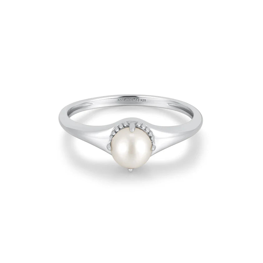 Silver ring with a pearl on a white background